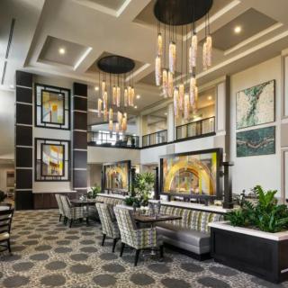 A luxurious lobby with modern decor, featuring elegant chandeliers and comfortable seating.