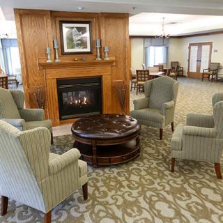 A cozy living room with a fireplace and comfortable seating arrangements.
