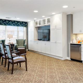 A modern living room with comfortable seating, a large TV, and elegant decor.