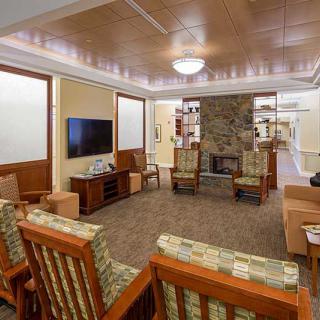 A cozy living room with a fireplace and comfortable seating arrangement.