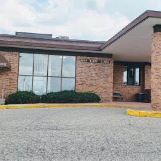 A modern brick building with large windows and a welcoming entrance.