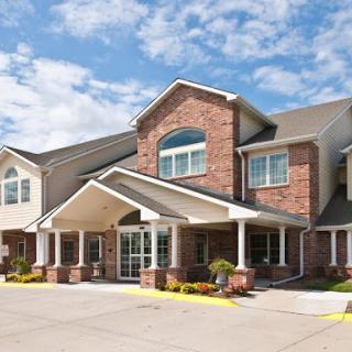 A welcoming exterior of a brick building with a sunny sky overhead.