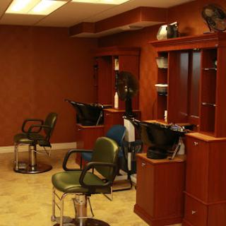 An interior view of a modern hair salon featuring barber chairs and wooden decor.