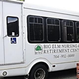 A transportation bus for Big Elm Nursing and Retirement Center, featuring accessibility options.