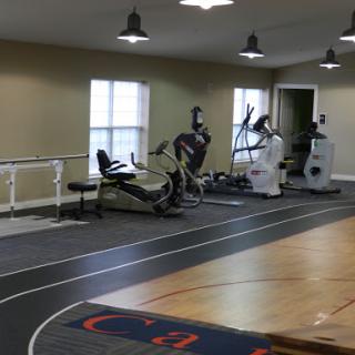A view of a gym featuring exercise machines and an indoor running track.