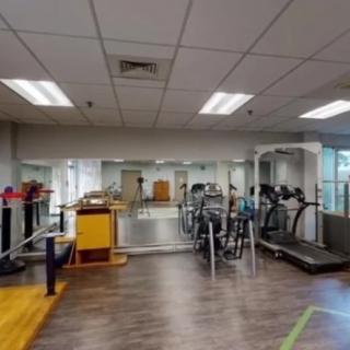 A gym interior featuring exercise equipment and mirrors.