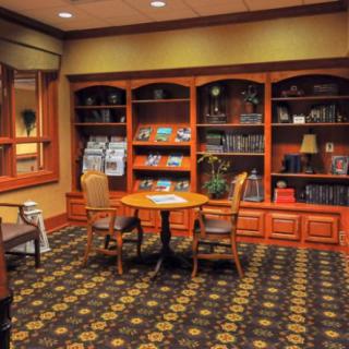 A cozy reading area with bookshelves and seating furniture.