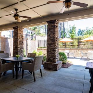 Outdoor patio with dining area and garden view.