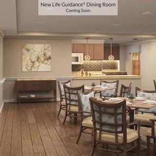 A modern dining room with wood flooring and elegant decor, featuring a kitchen area and stylish furniture arrangement.