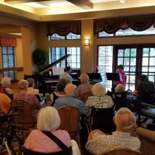 A lively musical performance for seniors in a community setting.