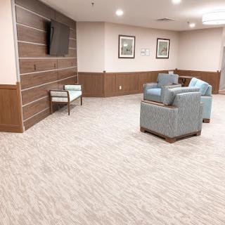 A modern lounge area featuring comfortable seating and a television.
