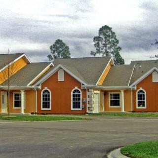 A row of orange residential houses on a suburban street.
