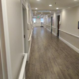 A well-lit hallway featuring modern design elements and wooden flooring.