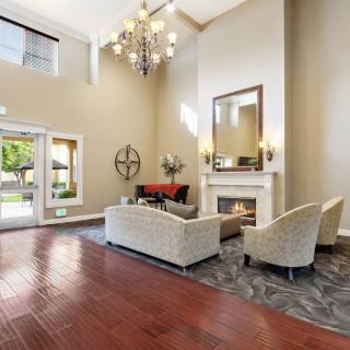 A modern lobby with elegant seating and a fireplace.