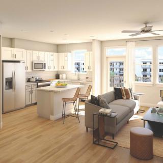 Modern apartment with an open floor plan featuring a kitchen and living room area.