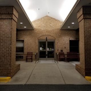 The entrance of a brick building illuminated at night.