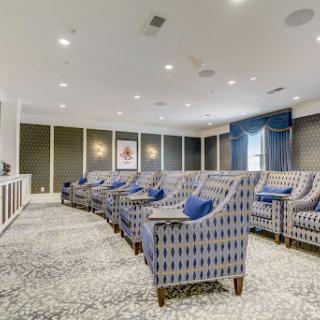 A stylish and comfortable home theater featuring plush seating and elegant decor.