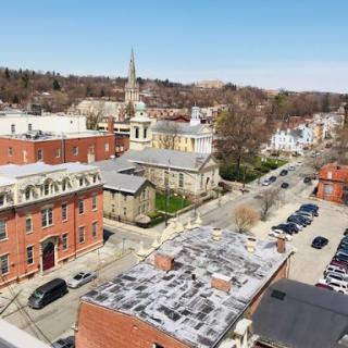 A scenic aerial view of a charming town showcasing its historic architecture and tree-lined streets.