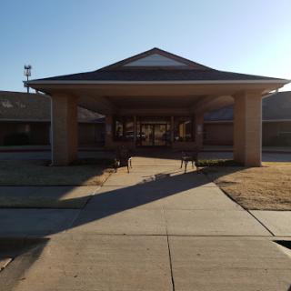 A welcoming entrance of a building, bathed in warm sunlight.