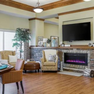 A cozy living room with a fireplace, television, and comfortable seating.
