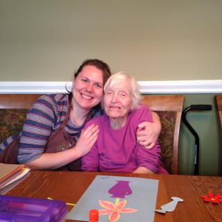 A joyful moment shared between two people as they engage in an art project.