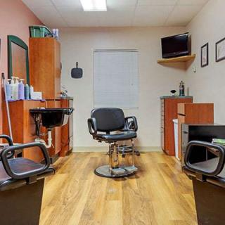 A cozy barber shop with modern chairs and wooden flooring.