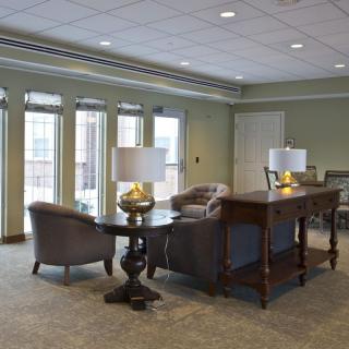 A well-lit lobby area with comfortable seating and decorative lamps.