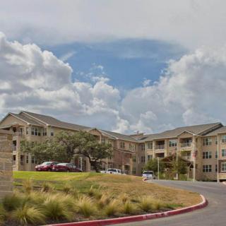 A view of a large residential apartment complex under a cloudy sky.