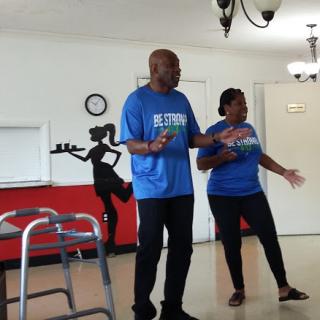 A lively performance by a couple, showcasing dance and movement in a vibrant indoor setting.
