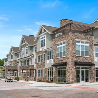 Modern residential apartment building with stone facade.