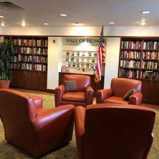 A cozy library reading area with comfortable chairs and bookshelves.