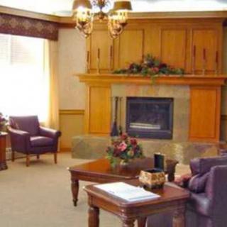 A cozy living room featuring a fireplace and traditional furniture.