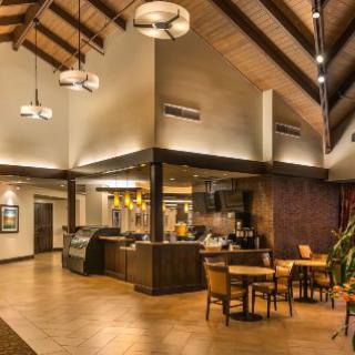 A cozy restaurant interior with modern design elements and wooden beams.
