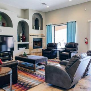 A cozy living room with modern decor, featuring comfortable seating and a fireplace.