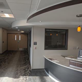 A spacious modern office lobby featuring a reception desk and bright lighting.