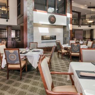 Elegant dining area with beautifully set tables and comfortable seating.