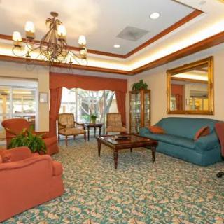 A cozy living room setting featuring comfortable seating and warm lighting.