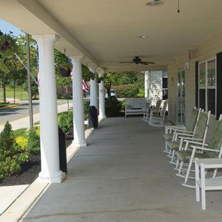 A charming porch with rocking chairs and classic columns, perfect for relaxation.