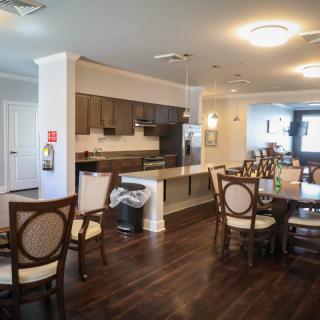 Modern kitchen and dining area with wooden flooring and stylish furnishings.