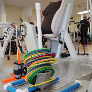 Physical therapy session with exercise equipment in a healthcare facility.