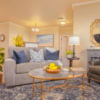 A cozy living room with a sofa, coffee table, and stylish home decor.