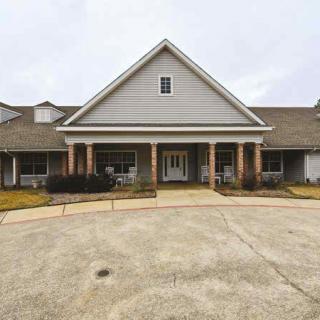 A front view of a residential building with a driveway.