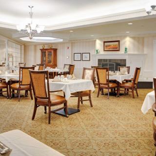 An elegant dining room with neatly arranged tables and chairs.