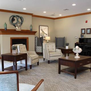 A cozy living room with elegant furniture and a fireplace, creating a warm and inviting atmosphere.