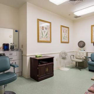 Interior of a hair salon with seating and wall art.