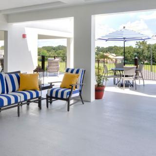 An inviting patio area with striped cushioned chairs and a scenic outdoor view.