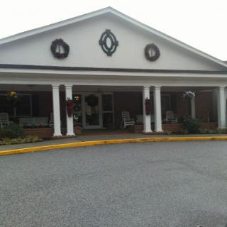 A welcoming entrance to a residential building, adorned with holiday decorations.