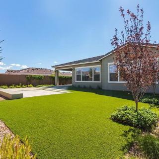 A suburban house with a well-maintained lawn and landscaping.