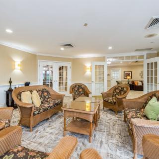 A cozy living room with wicker furniture and soft lighting.