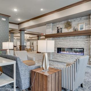 A modern living room with a cozy seating area and fireplace.